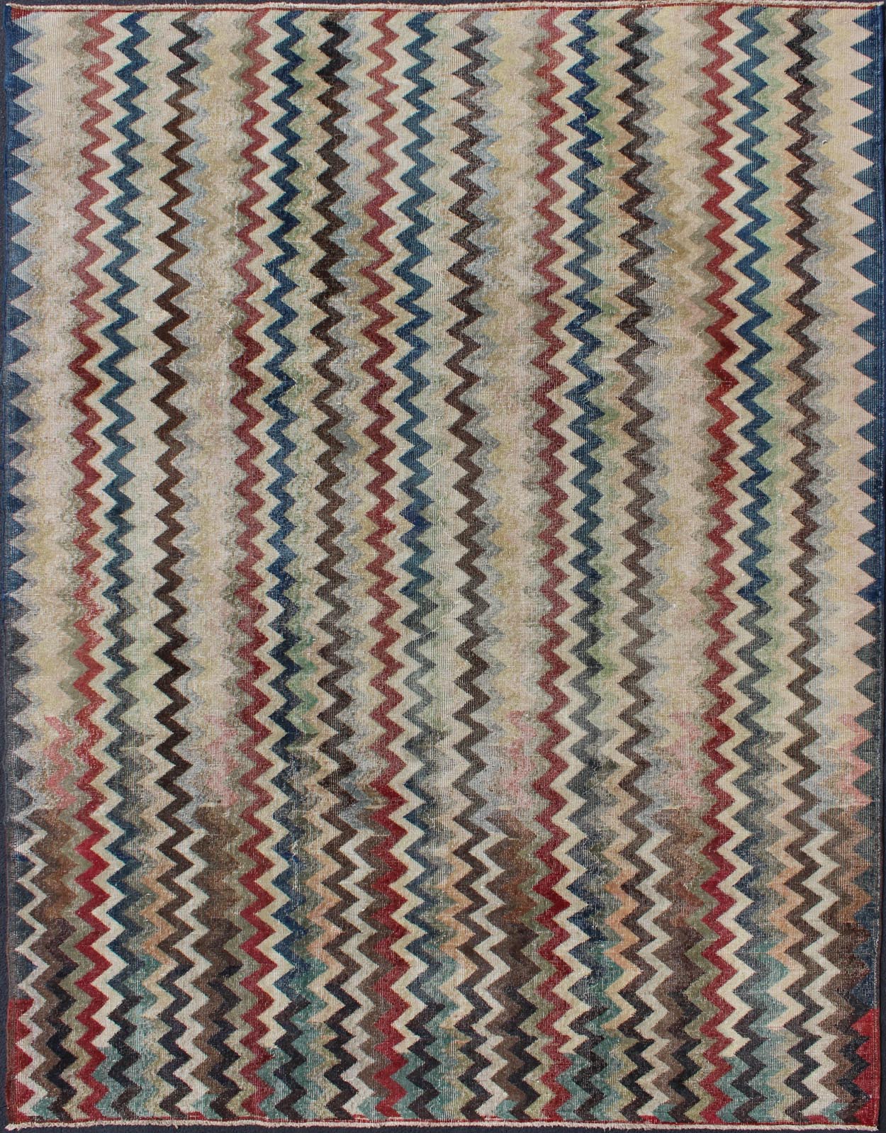 Mid - Century Turkish Modern Rug Rendered in zig - zag lines that run parallel to each other amidst an assortment of rich colors, this very unique rug showcases a modern design. Measures: 7'4 x 9'11. - Keivan Woven ArtsEN - 9801 - 4896Rug