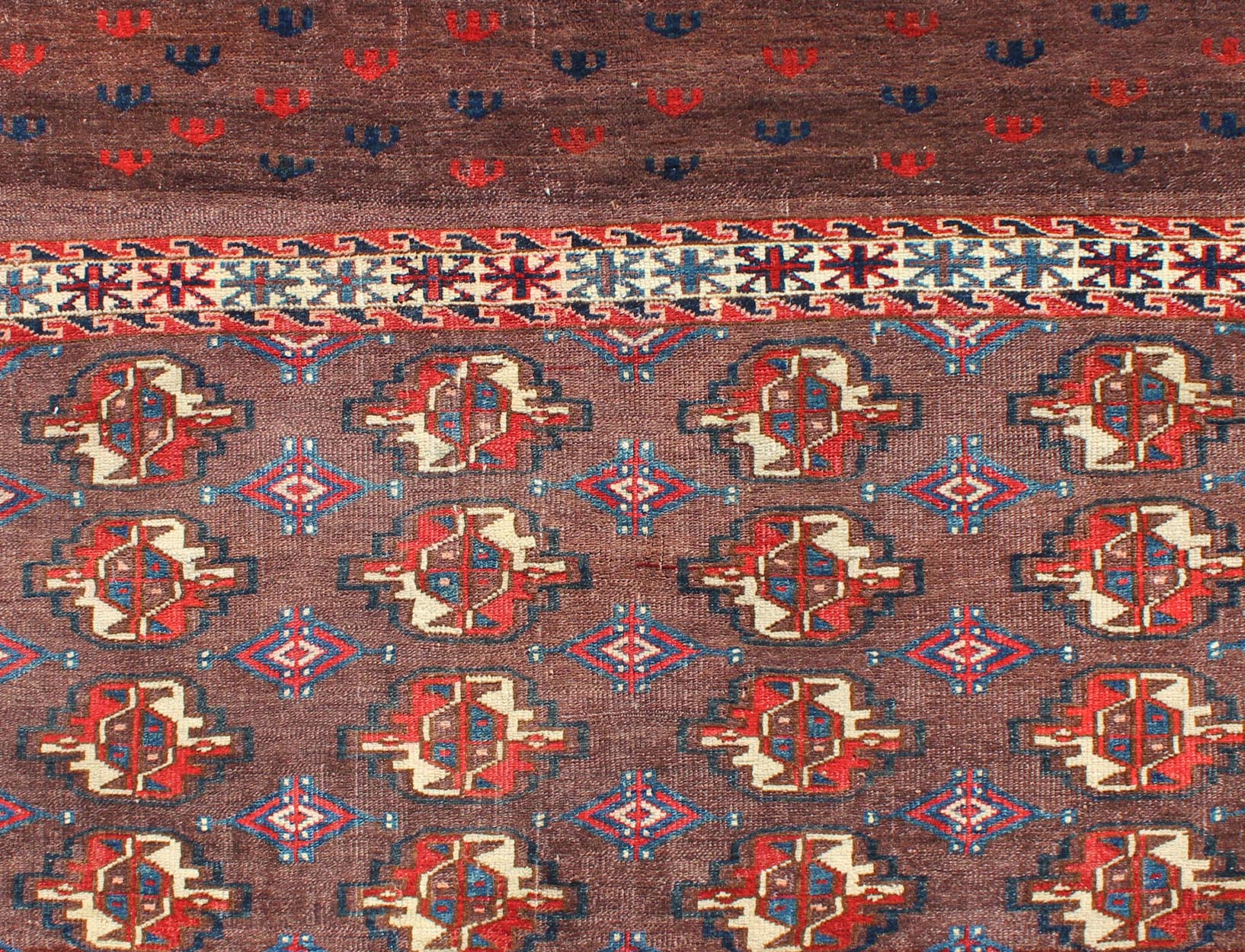 Early 20th Century Antique Tekke Rug with Brown Field and Tribal Motifs in Red, rugg - 1004, country of origin / type: Russia / Tribal, circa 1900 This piece is a rare antique Tekke carpet with delightful colors. The field consists of a chocolate ... - Keivan Woven ArtsG - 1004 - 2299Rug