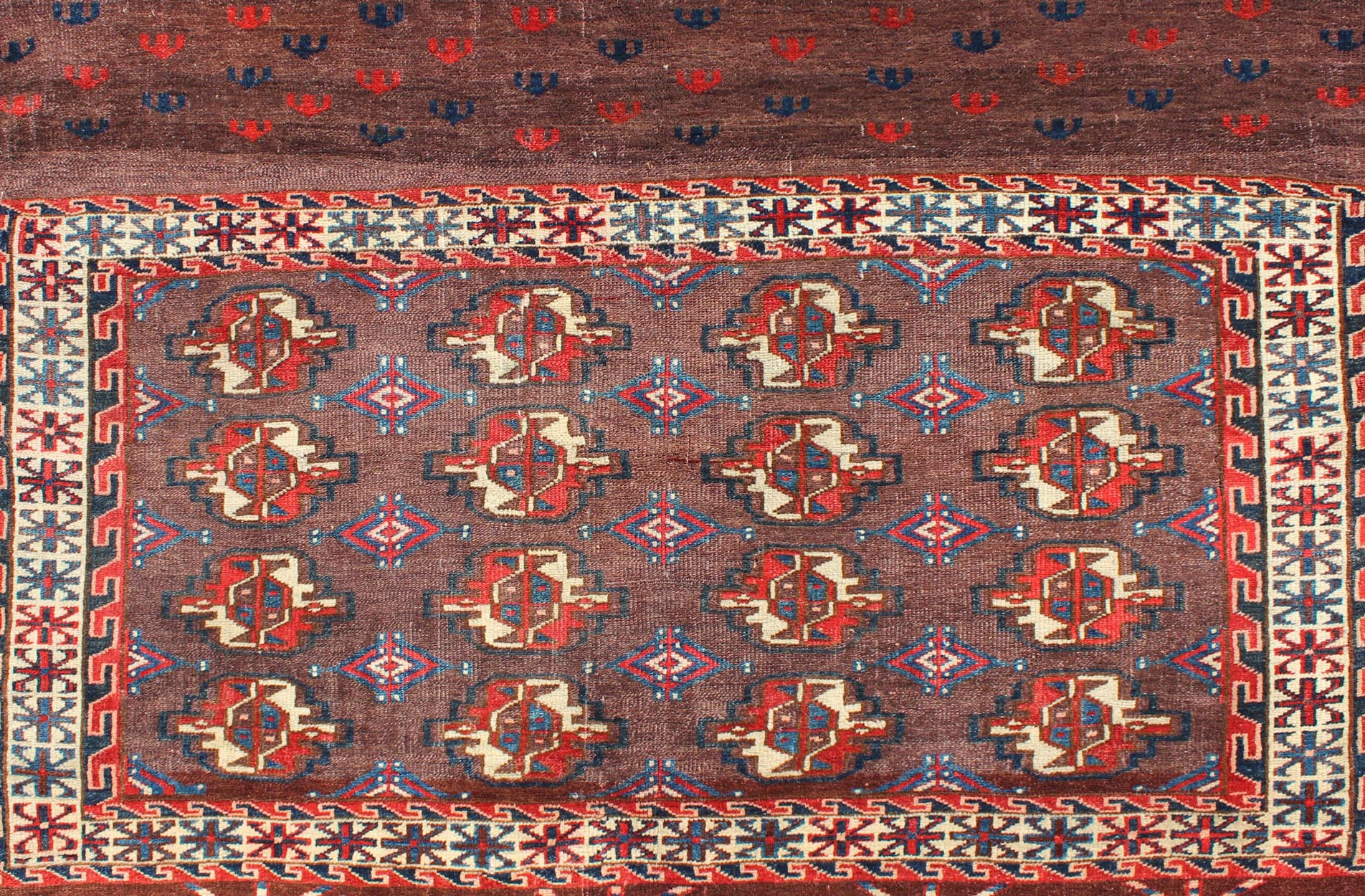 Early 20th Century Antique Tekke Rug with Brown Field and Tribal Motifs in Red, rugg - 1004, country of origin / type: Russia / Tribal, circa 1900 This piece is a rare antique Tekke carpet with delightful colors. The field consists of a chocolate ... - Keivan Woven ArtsG - 1004 - 2299Rug