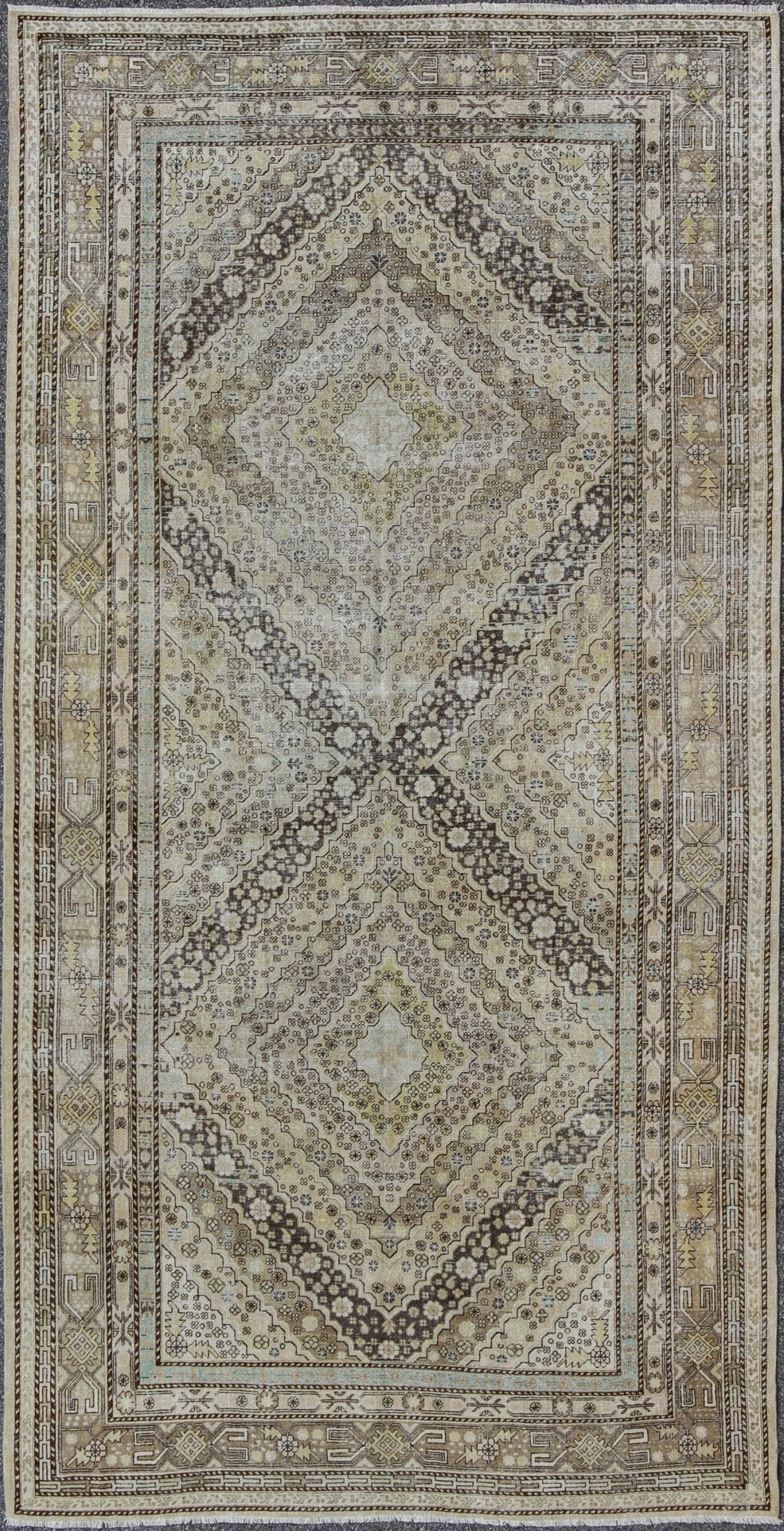 Antique Turkestanian Khotan rug with paired diamond geometric medallions, rug gld - 8495, country of origin / type: East Turkestan / Khotan, circa 1910. This delicately rendered antique Khotan rug was handcrafted in Turkestan during the early part... - Keivan Woven ArtsGLD - 8495 - 9098Rug