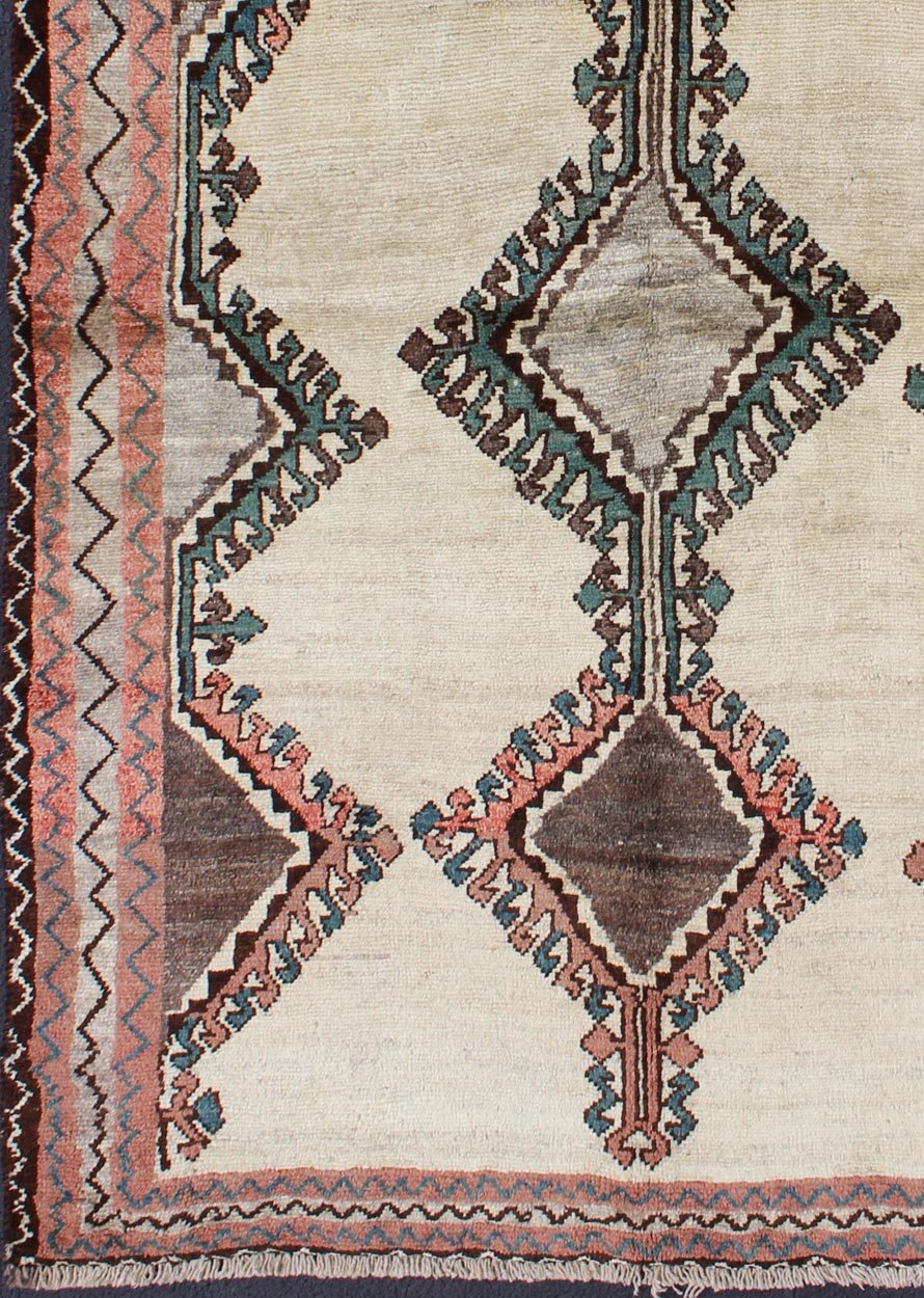 Keivan Woven Arts, H - 1205 - 06, 1950s Semi Antique Gabbeh Rug This Semi Antique Gabbeh carpet features a geometric design, including a repeating diamond design in its central field. Multiple tribal - patterned borders surround the field and frame entire... - Keivan Woven ArtsH - 1205 - 06 - 4148Rug