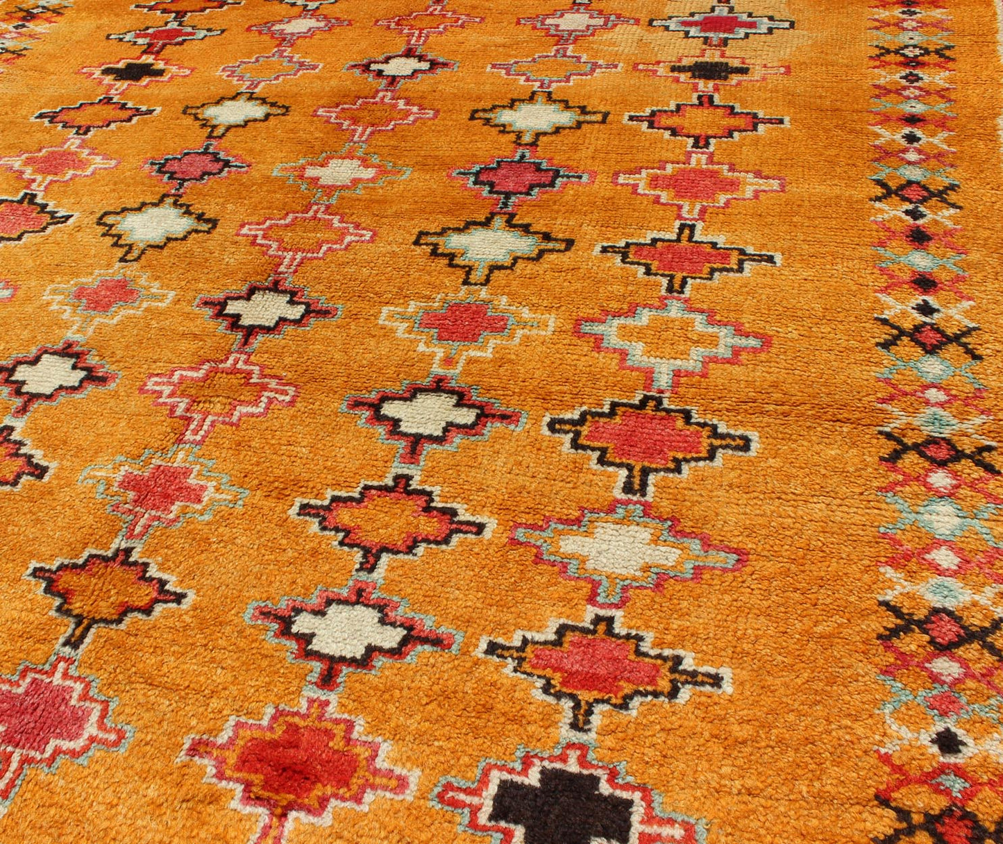 Saffron color antique Moroccan carpet with geometric patterns with orange, red, black, charcoal, white, light blue and ivory, rug H8 - 0802, country of origin / type: Morocco / Tribal, circa 1920. Crafted in the early 20th century, this gorgeous A... - Keivan Woven ArtsH8 - 0802 - 2121Rug