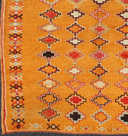 Saffron color antique Moroccan carpet with geometric patterns with orange, red, black, charcoal, white, light blue and ivory, rug H8 - 0802, country of origin / type: Morocco / Tribal, circa 1920. Crafted in the early 20th century, this gorgeous A... - Keivan Woven ArtsH8 - 0802 - 2121Rug