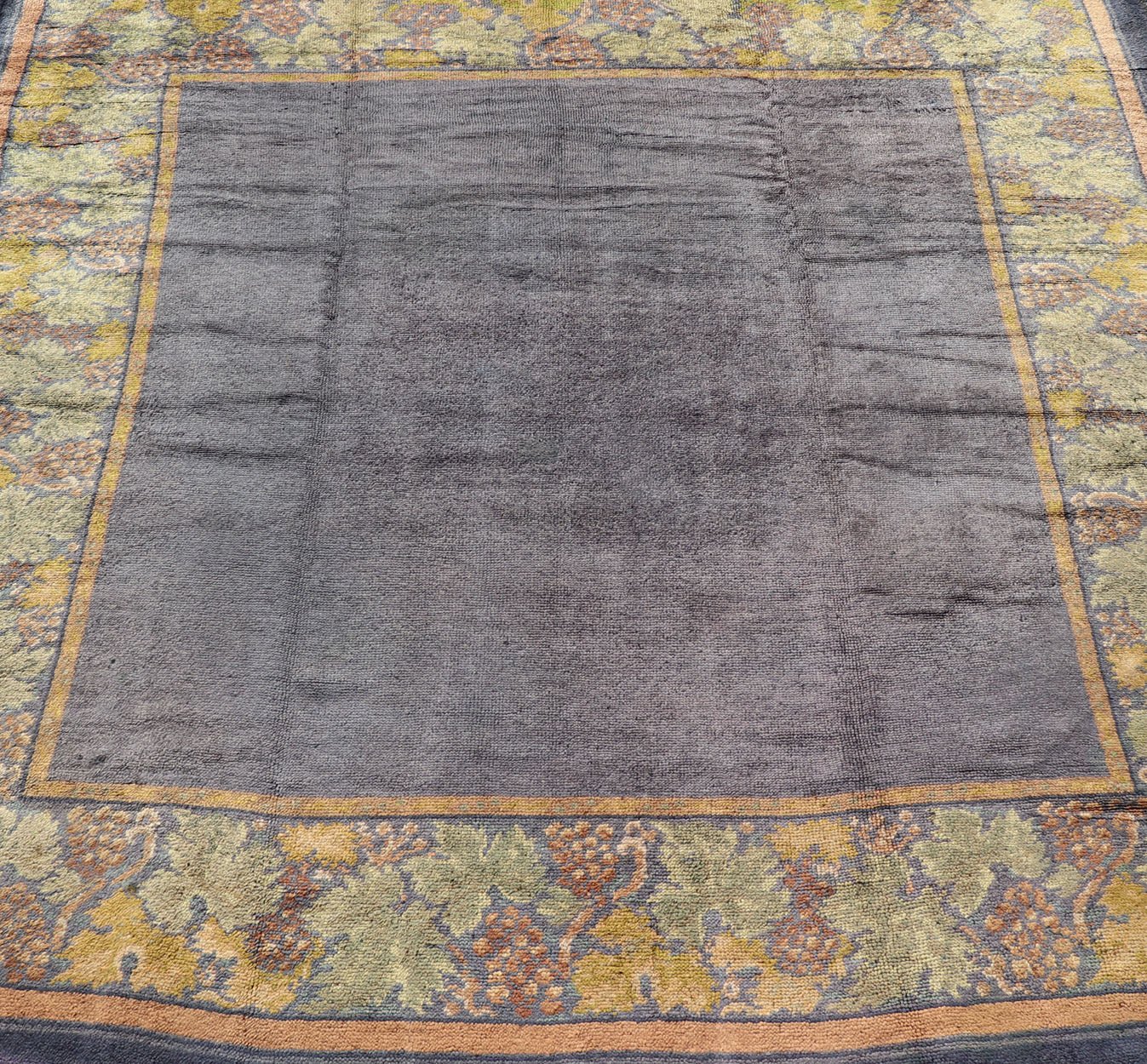 Antique Donegal carpet from Ireland in solid Purple Background and Floral Border in a near square size. Keivan Woven Arts / Rug/ HAS - 3327. Donegal rug, Antique Donegal. Measures: 10'6 x 10'10. Made in Ireland, this beautifully crafted Donegal ca... - Keivan Woven ArtsHAS - 3327 - 4176Rug
