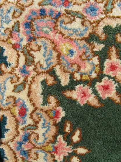Small Green Kerman Rug with Central Medallion and Matching Floral Border This mid - 20th century Kerman carpet from Iran features a center medallion and matching floral border set atop a green background. Measures: 2'0 x 3'0. - Keivan Woven ArtsHG - 78001 - 1265Rug