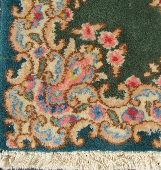 Small Green Kerman Rug with Central Medallion and Matching Floral Border This mid - 20th century Kerman carpet from Iran features a center medallion and matching floral border set atop a green background. Measures: 2'0 x 3'0. - Keivan Woven ArtsHG - 78001 - 1265Rug