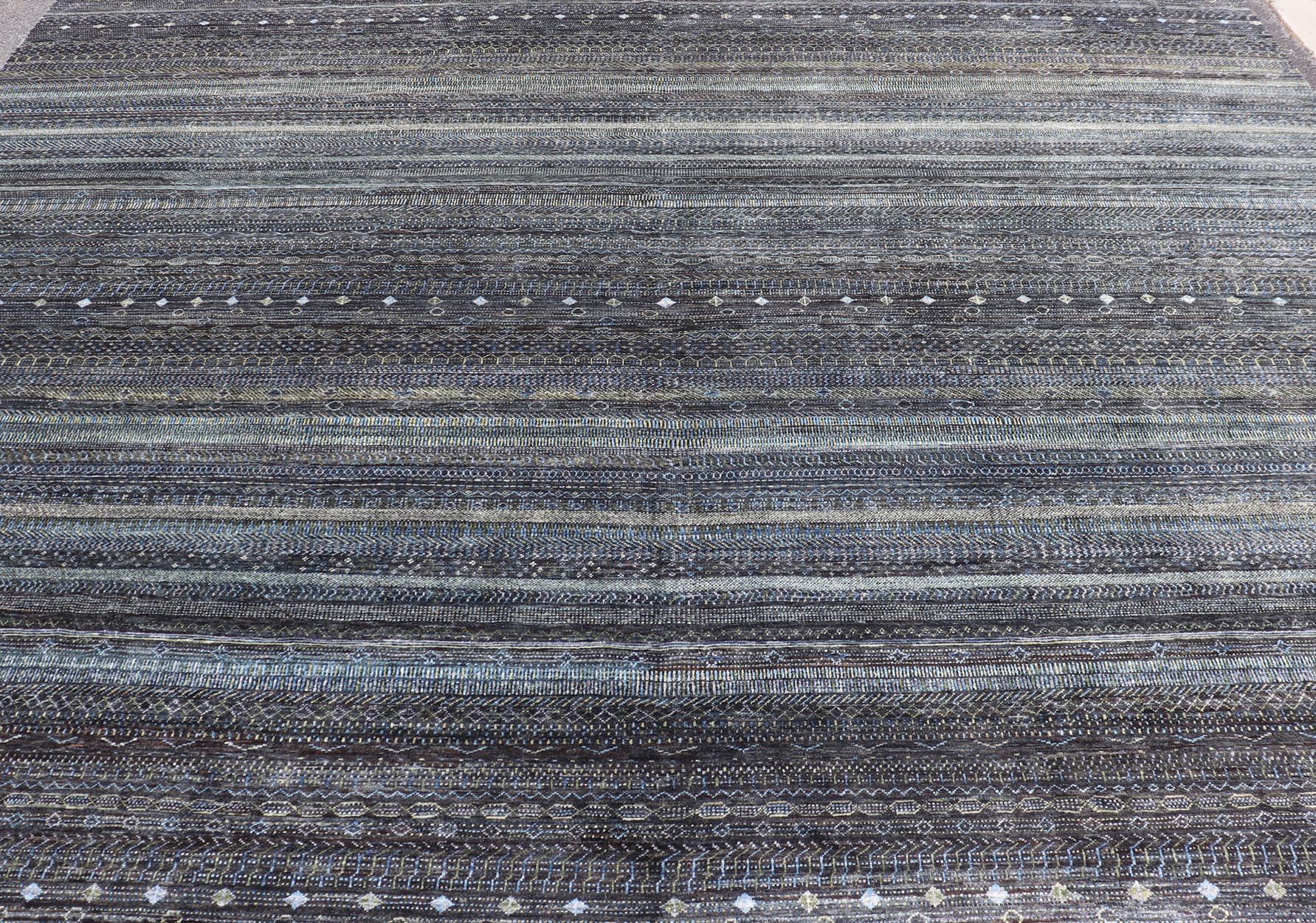 Large Modern Rug with Transitional Design in Shades of Black, Greens and Blue's. Keivan Woven Arts /origin/ India Circa / 2020 - Rug/ HUY - 99SK601 / 21st Century. Measures: 12'1 x 16'0 This fine hand - woven Modern Transitional rug features a beauti... - Keivan Woven ArtsHUY - 99SK601 - 25200Rug