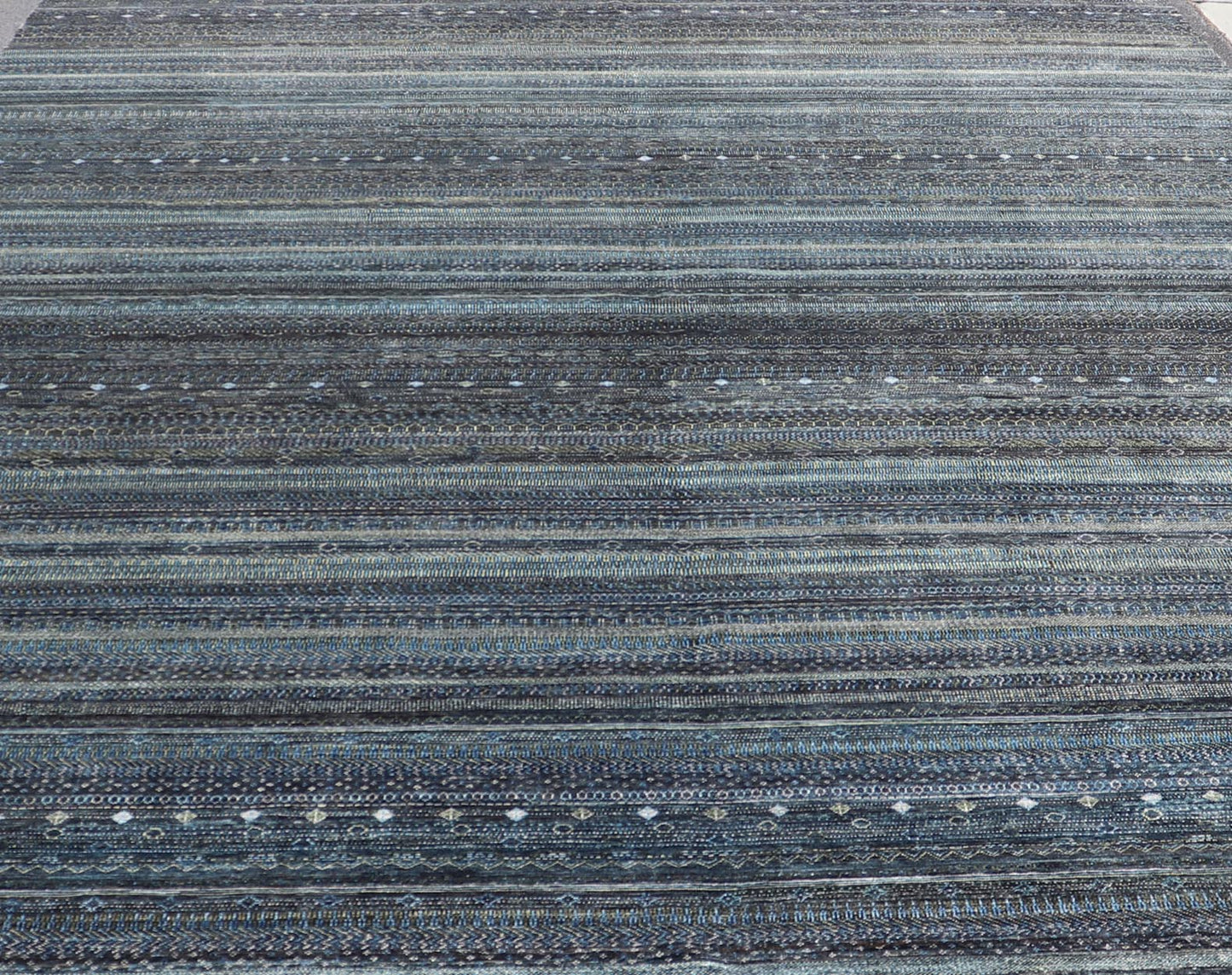Large Modern Rug with Transitional Design in Shades of Black, Greens and Blue's. Keivan Woven Arts /origin/ India Circa / 2020 - Rug/ HUY - 99SK601 / 21st Century. Measures: 12'1 x 16'0 This fine hand - woven Modern Transitional rug features a beauti... - Keivan Woven ArtsHUY - 99SK601 - 25200Rug