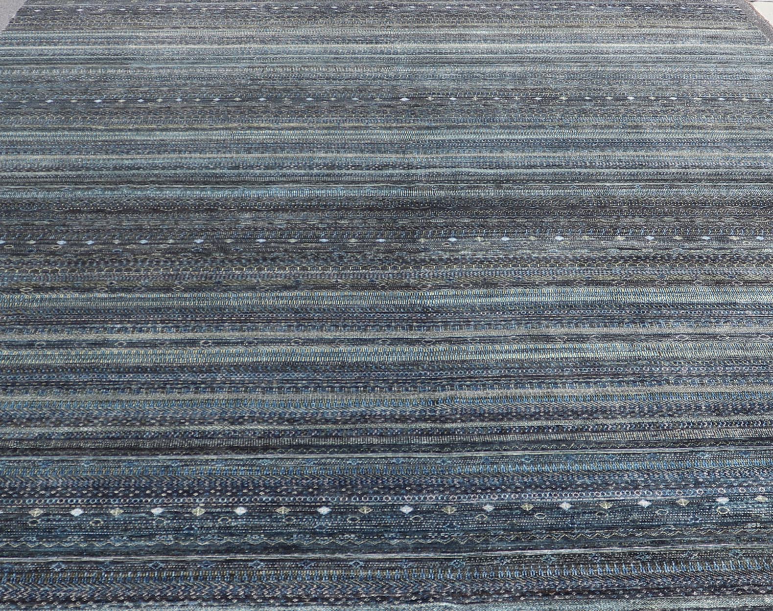 Large Modern Rug with Transitional Design in Shades of Black, Greens and Blue's. Keivan Woven Arts /origin/ India Circa / 2020 - Rug/ HUY - 99SK601 / 21st Century. Measures: 12'1 x 16'0 This fine hand - woven Modern Transitional rug features a beauti... - Keivan Woven ArtsHUY - 99SK601 - 25200Rug