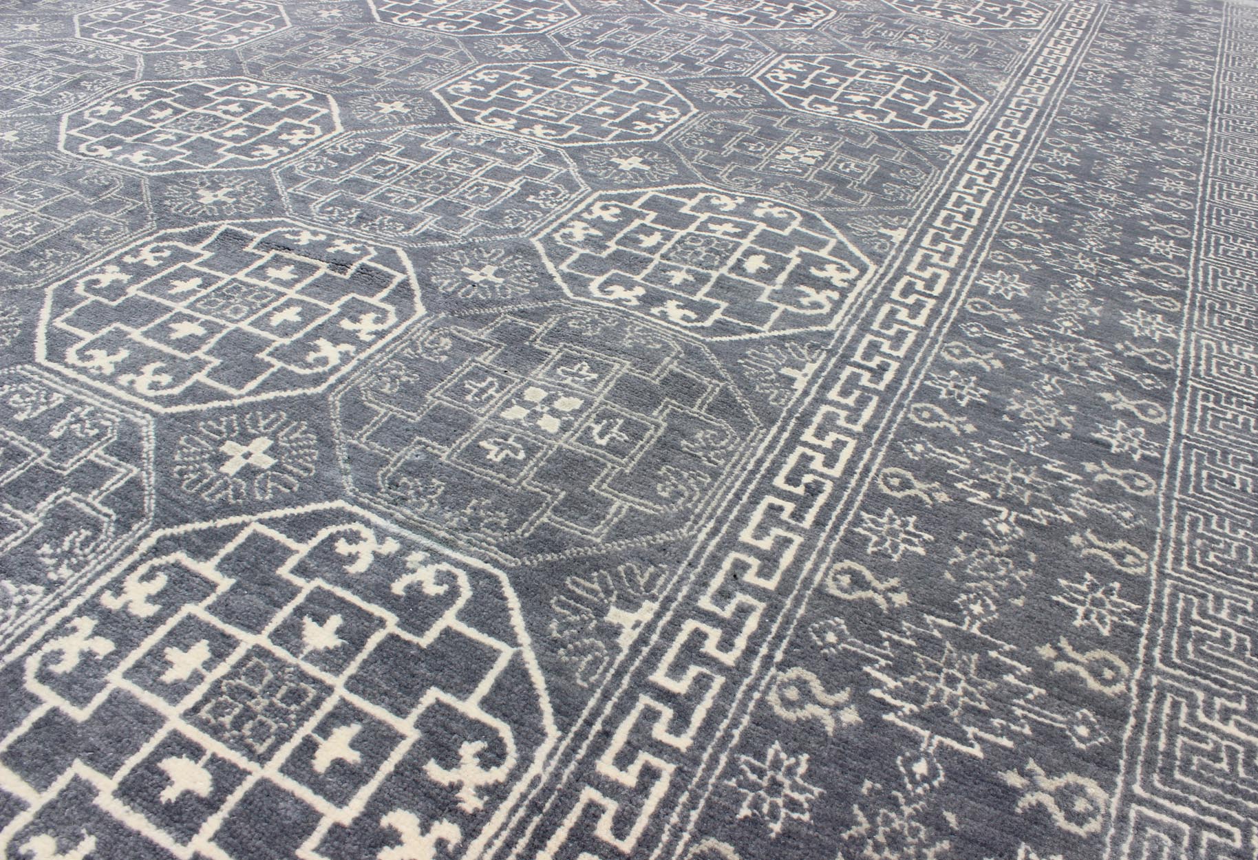 Antique Reproduction Indian Khotan Rug. Measures: 7'11 x 9'10. This attractive reproduction Khotan rug is a spectacular testament to the complexity of Turkestan design. The dark blue central field plays host to a stunning all - over display of inte... - Keivan Woven ArtsIN - BAM - 59077 - 8283