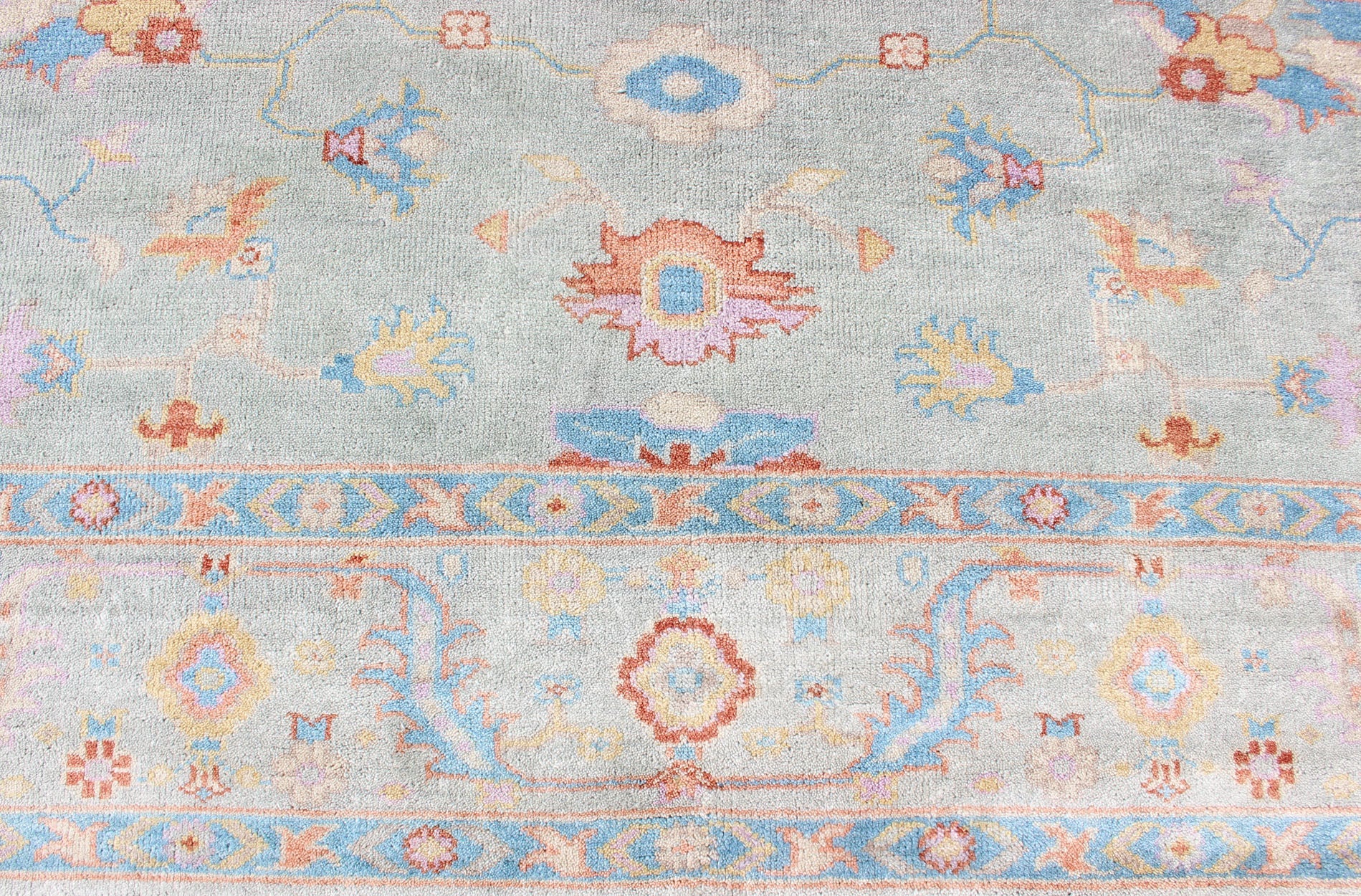 Hand - Knotted Floral Oushak Designed Rug in Light Blue, Orange, and Blue Measures 9'1 x 11'8 This wool Oushak was hand - knotted in the 2020's. The field and border both have a cool blue gray. The field and border also share floral and leaf... - Keivan Woven ArtsIN - CLR - 1002 - 13444