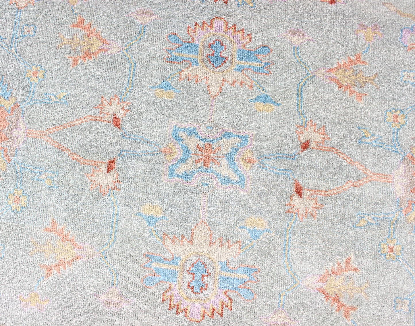 Hand - Knotted Floral Oushak Designed Rug in Light Blue, Orange, and Blue Measures 9'1 x 11'8 This wool Oushak was hand - knotted in the 2020's. The field and border both have a cool blue gray. The field and border also share floral and leaf... - Keivan Woven ArtsIN - CLR - 1002 - 13444
