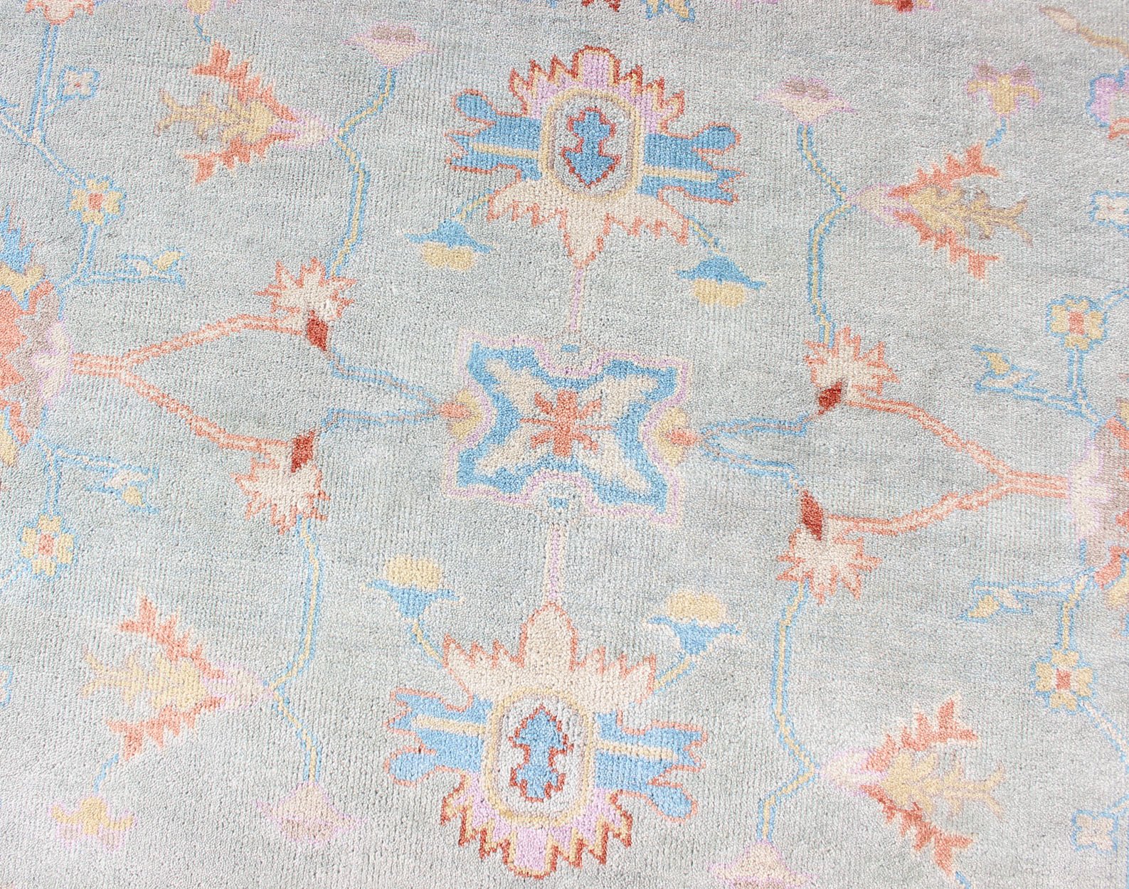 Hand - Knotted Floral Oushak Designed Rug in Light Blue, Orange, and Blue Measures 9'1 x 11'8 This wool Oushak was hand - knotted in the 2020's. The field and border both have a cool blue gray. The field and border also share floral and leaf... - Keivan Woven ArtsIN - CLR - 1002 - 13444