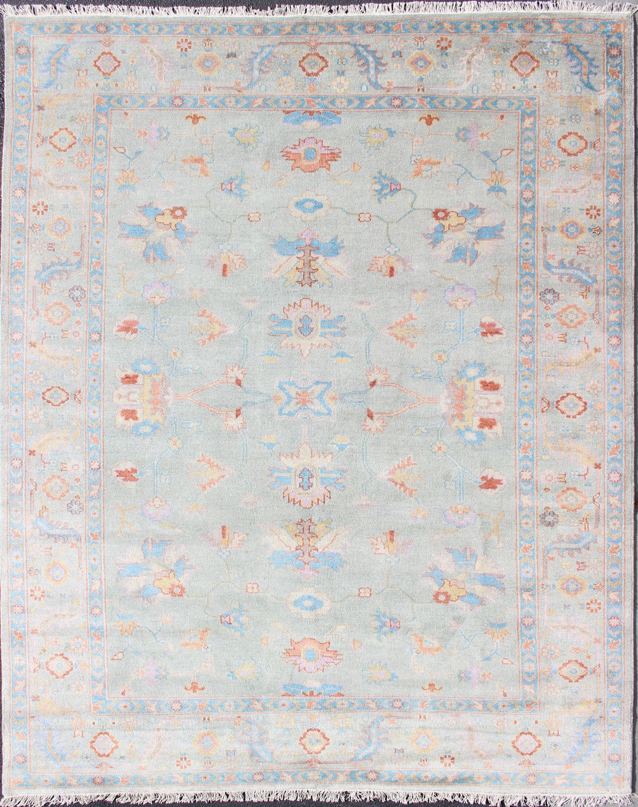 Hand - Knotted Floral Oushak Designed Rug in Light Blue, Orange, and Blue Measures 9'1 x 11'8 This wool Oushak was hand - knotted in the 2020's. The field and border both have a cool blue gray. The field and border also share floral and leaf... - Keivan Woven ArtsIN - CLR - 1002 - 13444