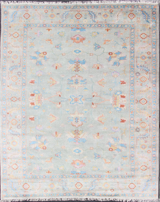 Hand - Knotted Floral Oushak Designed Rug in Light Blue, Orange, and Blue Measures 9'1 x 11'8 This wool Oushak was hand - knotted in the 2020's. The field and border both have a cool blue gray. The field and border also share floral and leaf... - Keivan Woven ArtsIN - CLR - 1002 - 13444