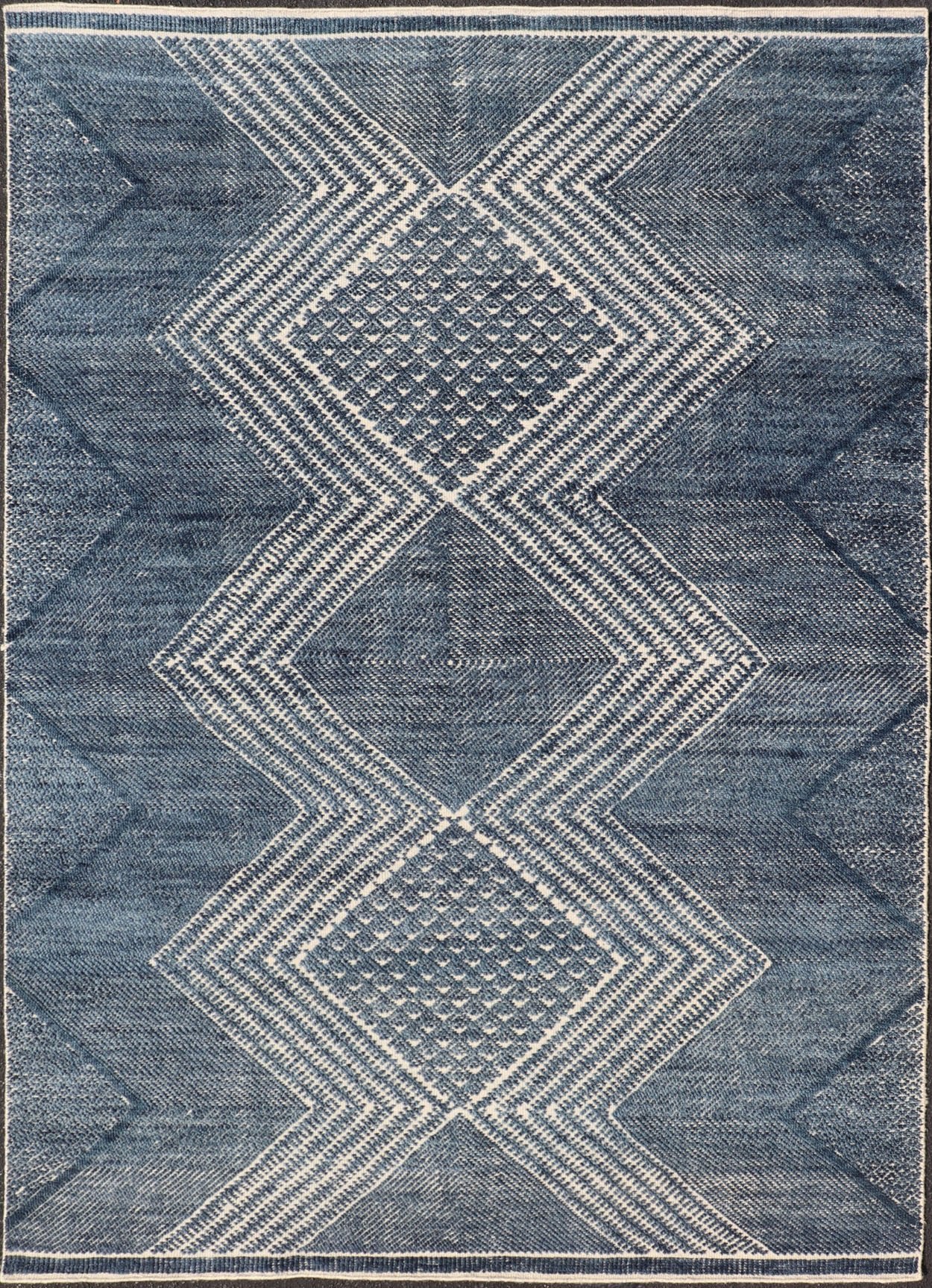 Modern Indian Area Rug with Tribal Design in Denim Blue and Ivory Measures 6'0 x 8'11 This elegant piece features a classic tribal stylization of vertical diamond medallions with a minimal twist. The medallions have a more modern de... - Keivan Woven ArtsIN - ILM - 165 - CB - 4018 - 20922