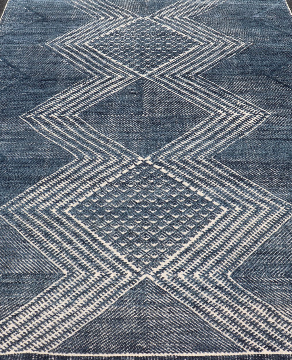 Modern Indian Area Rug with Tribal Design in Denim Blue and Ivory Measures 6'0 x 8'11 This elegant piece features a classic tribal stylization of vertical diamond medallions with a minimal twist. The medallions have a more modern de... - Keivan Woven ArtsIN - ILM - 165 - CB - 4018 - 20922