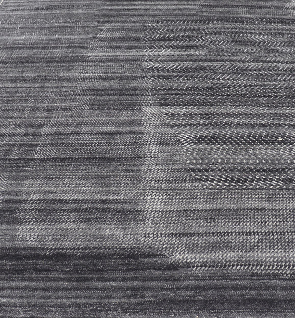 This modern abstract rug was hand - knotted with wool in India. The design features no definite pattern, but "scrapes" of ivory on a smoky charcoal background, loosely giving a tire track likeness. This piece is contemporary and neutral, yet masculine an... - Keivan Woven ArtsIN - ILM - 3391 - MN - 0043 - 18156