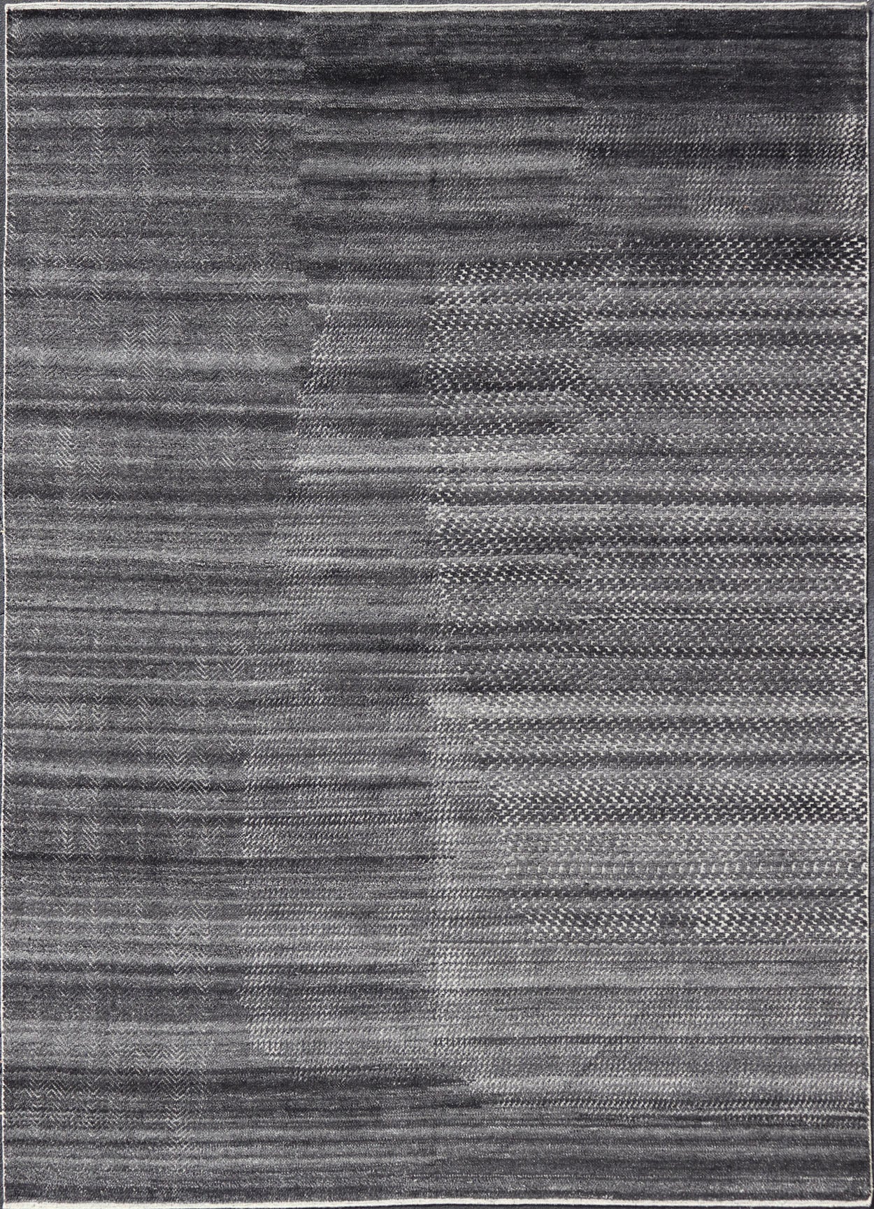 This modern abstract rug was hand - knotted with wool in India. The design features no definite pattern, but "scrapes" of ivory on a smoky charcoal background, loosely giving a tire track likeness. This piece is contemporary and neutral, yet masculine an... - Keivan Woven ArtsIN - ILM - 3391 - MN - 0043 - 18156