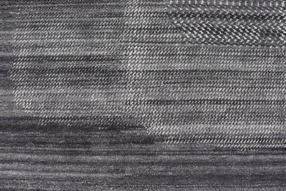 This modern abstract rug was hand - knotted with wool in India. The design features no definite pattern, but "scrapes" of ivory on a smoky charcoal background, loosely giving a tire track likeness. This piece is contemporary and neutral, yet masculine an... - Keivan Woven ArtsIN - ILM - 3391 - MN - 0043 - 18156