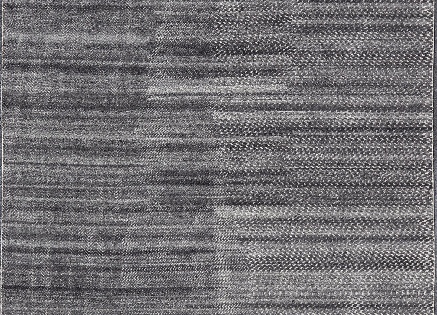 This modern abstract rug was hand - knotted with wool in India. The design features no definite pattern, but "scrapes" of ivory on a smoky charcoal background, loosely giving a tire track likeness. This piece is contemporary and neutral, yet masculine an... - Keivan Woven ArtsIN - ILM - 3391 - MN - 0043 - 18156