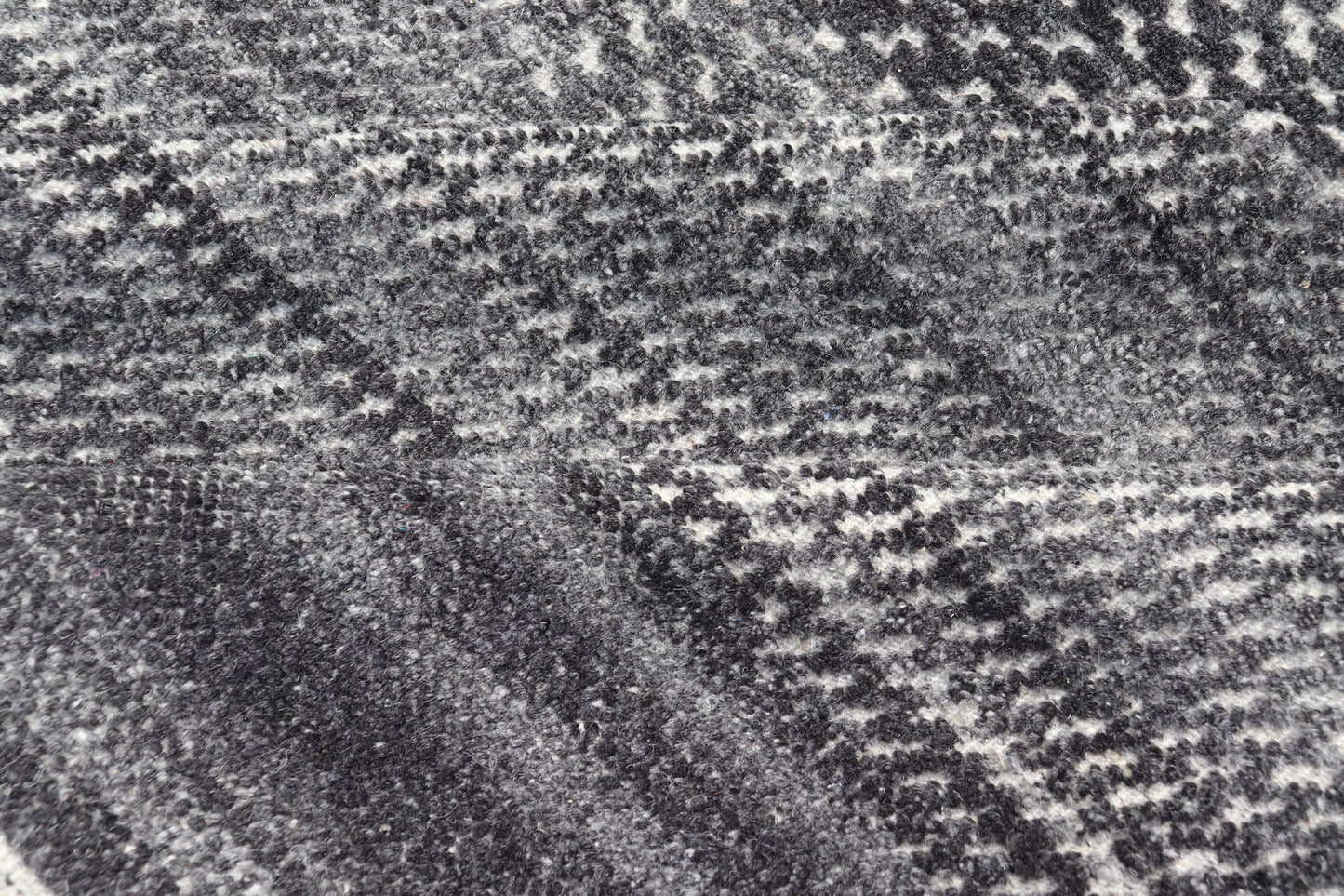 This modern abstract rug was hand - knotted with wool in India. The design features no definite pattern, but "scrapes" of ivory on a smoky charcoal background, loosely giving a tire track likeness. This piece is contemporary and neutral, yet masculine an... - Keivan Woven ArtsIN - ILM - 3391 - MN - 0043 - 18156