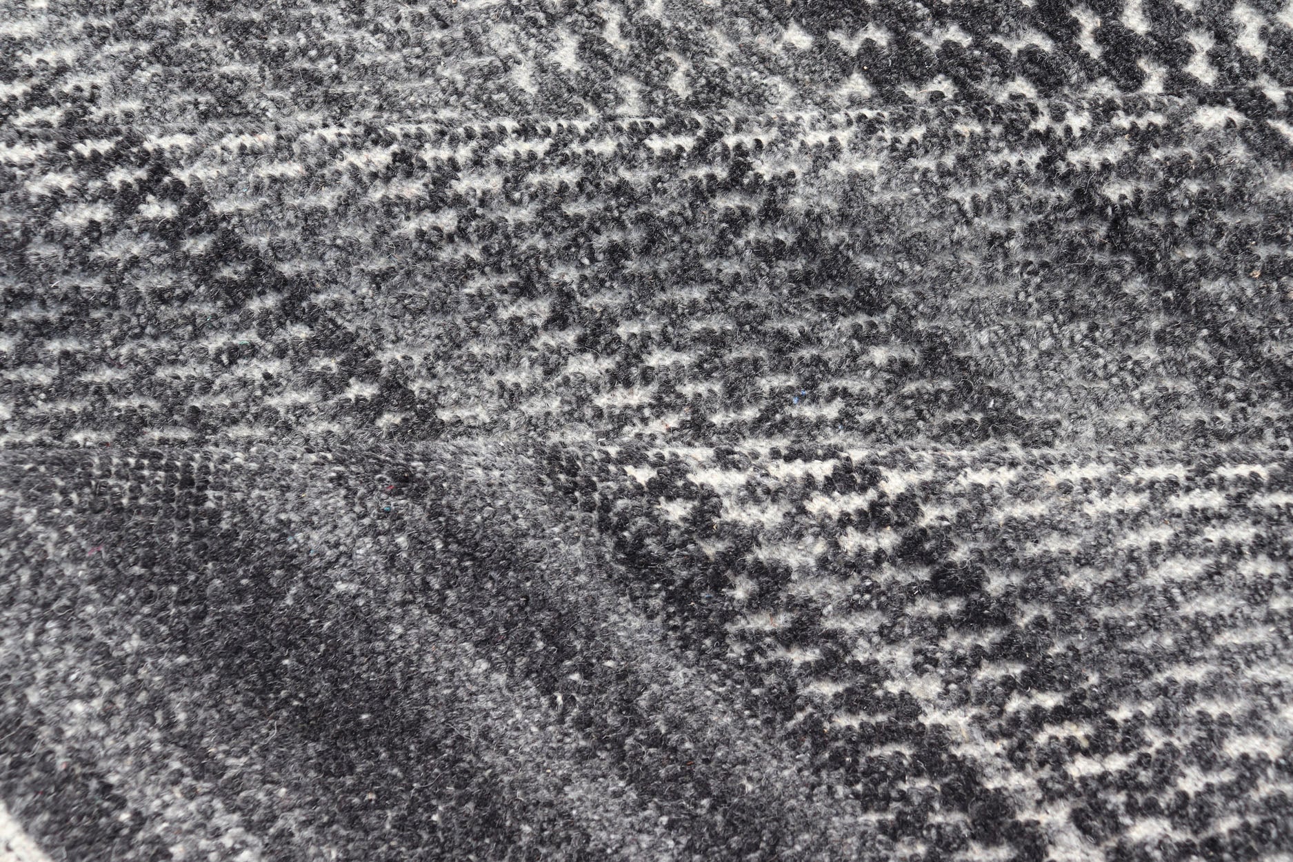 This modern abstract rug was hand - knotted with wool in India. The design features no definite pattern, but "scrapes" of ivory on a smoky charcoal background, loosely giving a tire track likeness. This piece is contemporary and neutral, yet masculine an... - Keivan Woven ArtsIN - ILM - 3391 - MN - 0043 - 18156