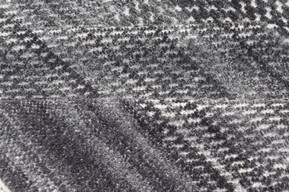 This modern abstract rug was hand - knotted with wool in India. The design features no definite pattern, but "scrapes" of ivory on a smoky charcoal background, loosely giving a tire track likeness. This piece is contemporary and neutral, yet masculine an... - Keivan Woven ArtsIN - ILM - 3391 - MN - 0043 - 18156