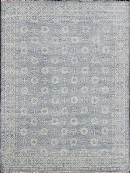 Vintage Khotan Rug in White and Blue. Measures: 9'2 x 12'1. This superb woolen Khotan hailing from India features an all over design with geometric shapes and patterning enclosed within a complementary border. The rug is rendered in shades of whi... - Keivan Woven ArtsIN - JAI - 5385 - 6967Rug