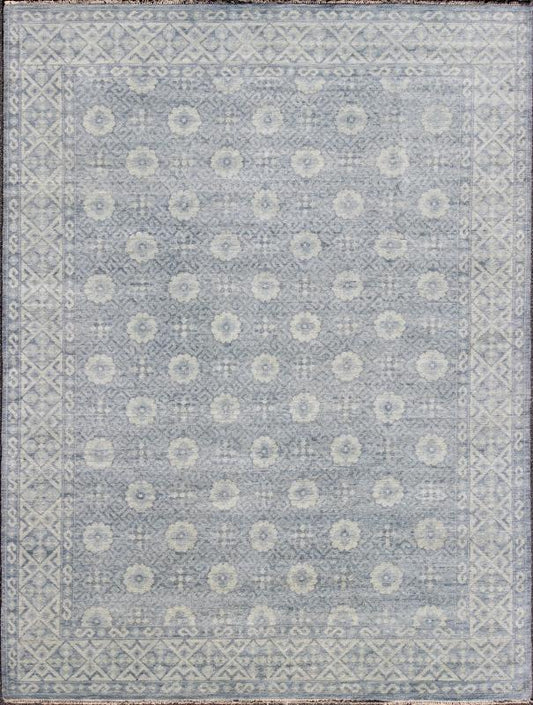Vintage Khotan Rug in White and Blue. Measures: 9'2 x 12'1. This superb woolen Khotan hailing from India features an all over design with geometric shapes and patterning enclosed within a complementary border. The rug is rendered in shades of whi... - Keivan Woven ArtsIN - JAI - 5385 - 6967Rug