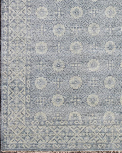 Vintage Khotan Rug in White and Blue. Measures: 9'2 x 12'1. This superb woolen Khotan hailing from India features an all over design with geometric shapes and patterning enclosed within a complementary border. The rug is rendered in shades of whi... - Keivan Woven ArtsIN - JAI - 5385 - 6967Rug