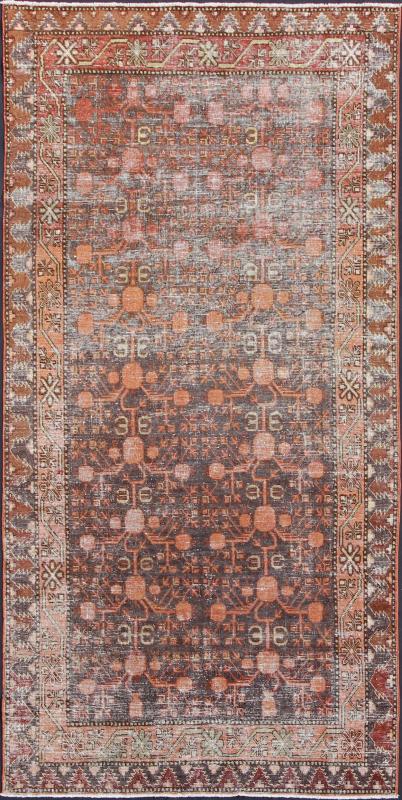 Antique Khotan Carpet An antique, early 20th century, Central Asian Khotan rug with traditional all - over pomegranate pattern on a charcoal field surrounded by multiple complementary floral borders. Measures: 4'11 x 9'9. - Keivan Woven ArtsKBE - 3462 - 7221Rug