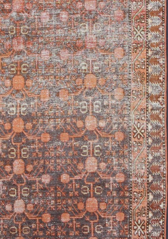 Antique Khotan Carpet An antique, early 20th century, Central Asian Khotan rug with traditional all - over pomegranate pattern on a charcoal field surrounded by multiple complementary floral borders. Measures: 4'11 x 9'9. - Keivan Woven ArtsKBE - 3462 - 7221Rug