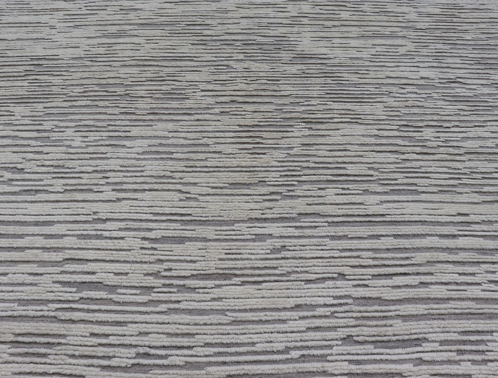 Measures 11'8 x 14' This Squared shape modern area rug was hand - knotted. Common with modern rugs, this piece features hi low and no defined border in neutral colors such as off white, cream, gray taupe. The field is a wood grain - like pattern, ut... - Keivan Woven ArtsKHN - 43558 - TR - 857 - 20866Rug