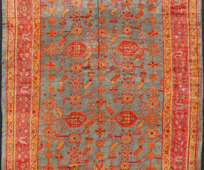 Early 20th century antique Turkish Oushak rug with flowers and geometric motifs in blue background and red border. Keivan Woven Arts / rug L11 - 0404, country of origin / type: Turkey / Oushak, circa 1910 Produced in early 20th century Turkey, thi... - Keivan Woven ArtsL11 - 0404 - 2549Rug