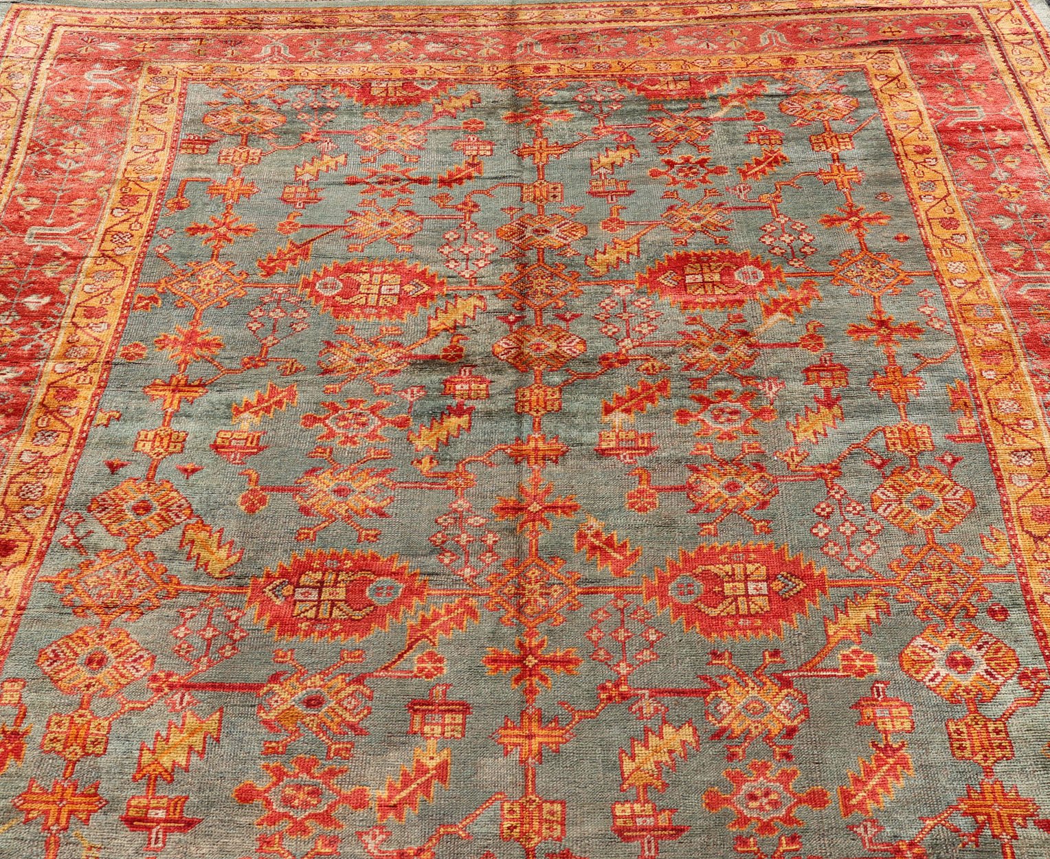 Early 20th century antique Turkish Oushak rug with flowers and geometric motifs in blue background and red border. Keivan Woven Arts / rug L11 - 0404, country of origin / type: Turkey / Oushak, circa 1910 Produced in early 20th century Turkey, thi... - Keivan Woven ArtsL11 - 0404 - 2549Rug