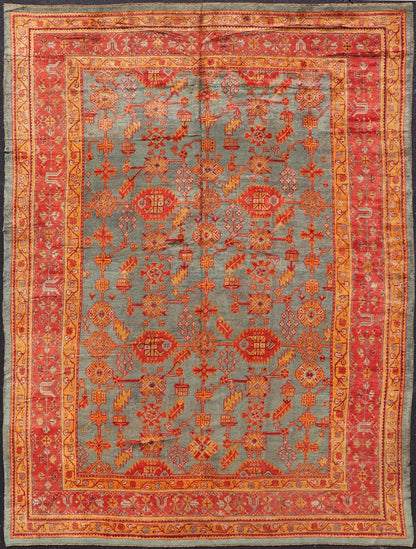 Early 20th century antique Turkish Oushak rug with flowers and geometric motifs in blue background and red border. Keivan Woven Arts / rug L11 - 0404, country of origin / type: Turkey / Oushak, circa 1910 Produced in early 20th century Turkey, thi... - Keivan Woven ArtsL11 - 0404 - 2549Rug