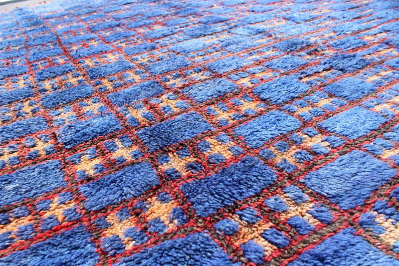 Vintage Moroccan Rug This unique vintage Moroccan carpet is characterized by a saturated, bold blue color and dramatic berber symbols. The alternating checkerboard pattern is outlined in red with tan cross motifs while its thick pile has a soft ... - Keivan Woven ArtsLCB - 136601 - 7309Rug