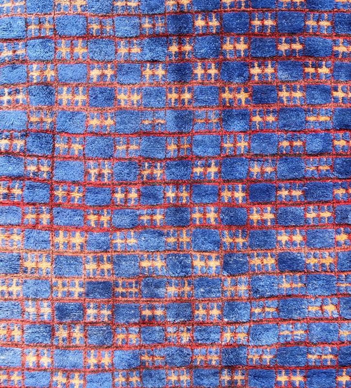 Vintage Moroccan Rug This unique vintage Moroccan carpet is characterized by a saturated, bold blue color and dramatic berber symbols. The alternating checkerboard pattern is outlined in red with tan cross motifs while its thick pile has a soft ... - Keivan Woven ArtsLCB - 136601 - 7309Rug
