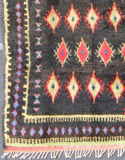 Charcoal Black Background Unique Vintage Moroccan Rug in Red and Yellow Measures: 4'9'' x 9'10''. Featuring a central charcoal field full of red and yellow diamond - shaped motifs, this unique Moroccan rug displays a harmonious and rich color p... - Keivan Woven ArtsLCB - 136610 - 7321Rug