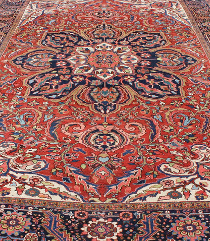 Large Persian Heriz Rug with Geometric Medallion in Rust, Pink, Green and Blue. Keivan Woven Arts / Rug / M14 - 0501, country of origin / type: Iran /Heriz, circa 1930. Measures: 10'1 x 13'5. Masterful craftsmanship and a strong tribal design make... - Keivan Woven ArtsM14 - 0501 - 5371Rug