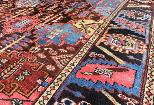 Vintage Persian Bakhtiari Rug This vintage Bakhtiari has an all - over garden pattern. The repeating border of flowers and vines include yellow, blue and red set on a brown background. Measures: 7'3 x 9'7. - Keivan Woven ArtsM14 - 0514 - 5385Rug