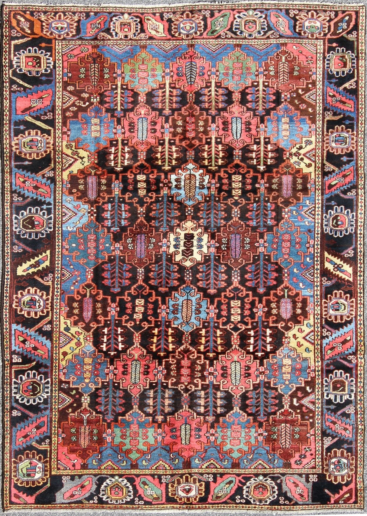Vintage Persian Bakhtiari Rug This vintage Bakhtiari has an all - over garden pattern. The repeating border of flowers and vines include yellow, blue and red set on a brown background. Measures: 7'3 x 9'7. - Keivan Woven ArtsM14 - 0514 - 5385Rug