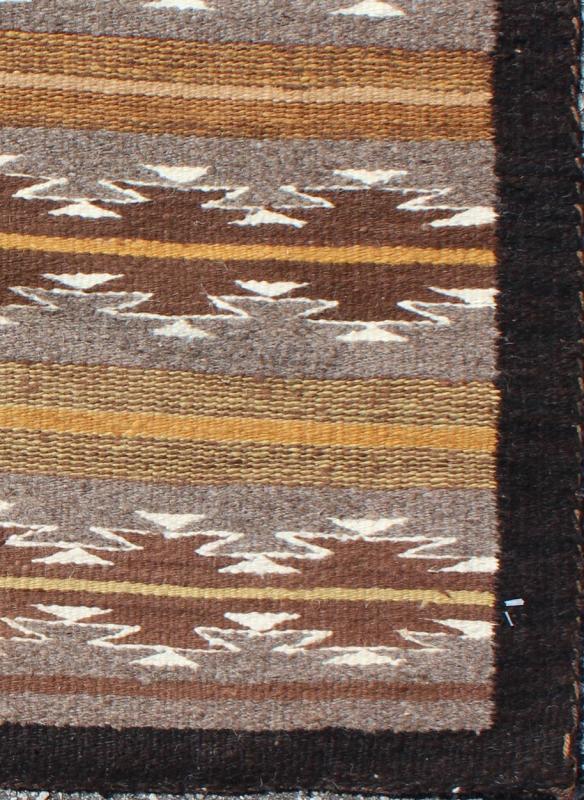 Earthy Tones USA Navajo Kilim rug with Black Border Tribal Design 1940s Navajo Tribal Kilim with geometric design in Marigold, grey and black rug M14 - 0902, country of origin / type: America / Navajo, circa 1940 This intriguing antique Nav... - Keivan Woven ArtsM14 - 0902 - 5930Rug
