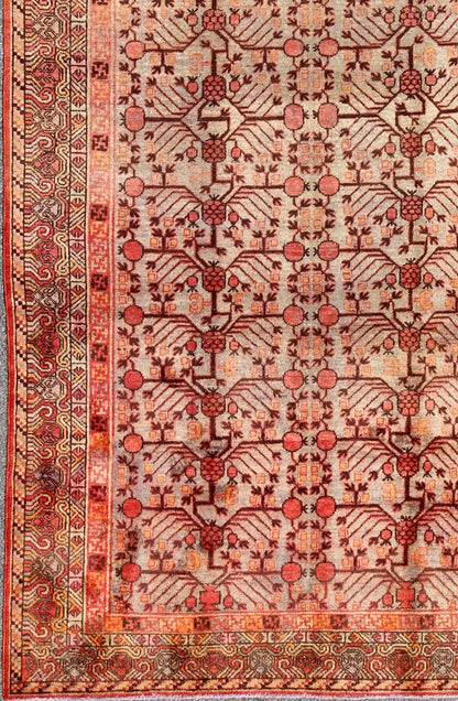 Antique Khotan Rug This attractive antique Khotan rug is a spectacular testament to the complexity of Turkestan design. The neutral tone of the central field plays host to a stunning display of the entwined tree of life bearing budding blossoms ... - Keivan Woven ArtsMP - 1301 - 339 - 3984Rug