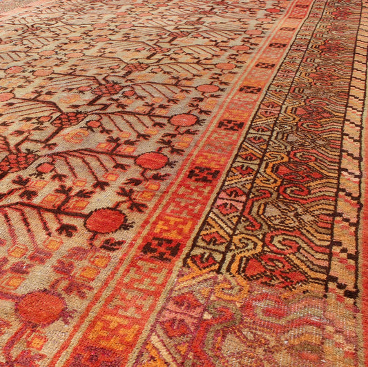 Antique Khotan Rug This attractive antique Khotan rug is a spectacular testament to the complexity of Turkestan design. The neutral tone of the central field plays host to a stunning display of the entwined tree of life bearing budding blossoms ... - Keivan Woven ArtsMP - 1301 - 339 - 3984Rug