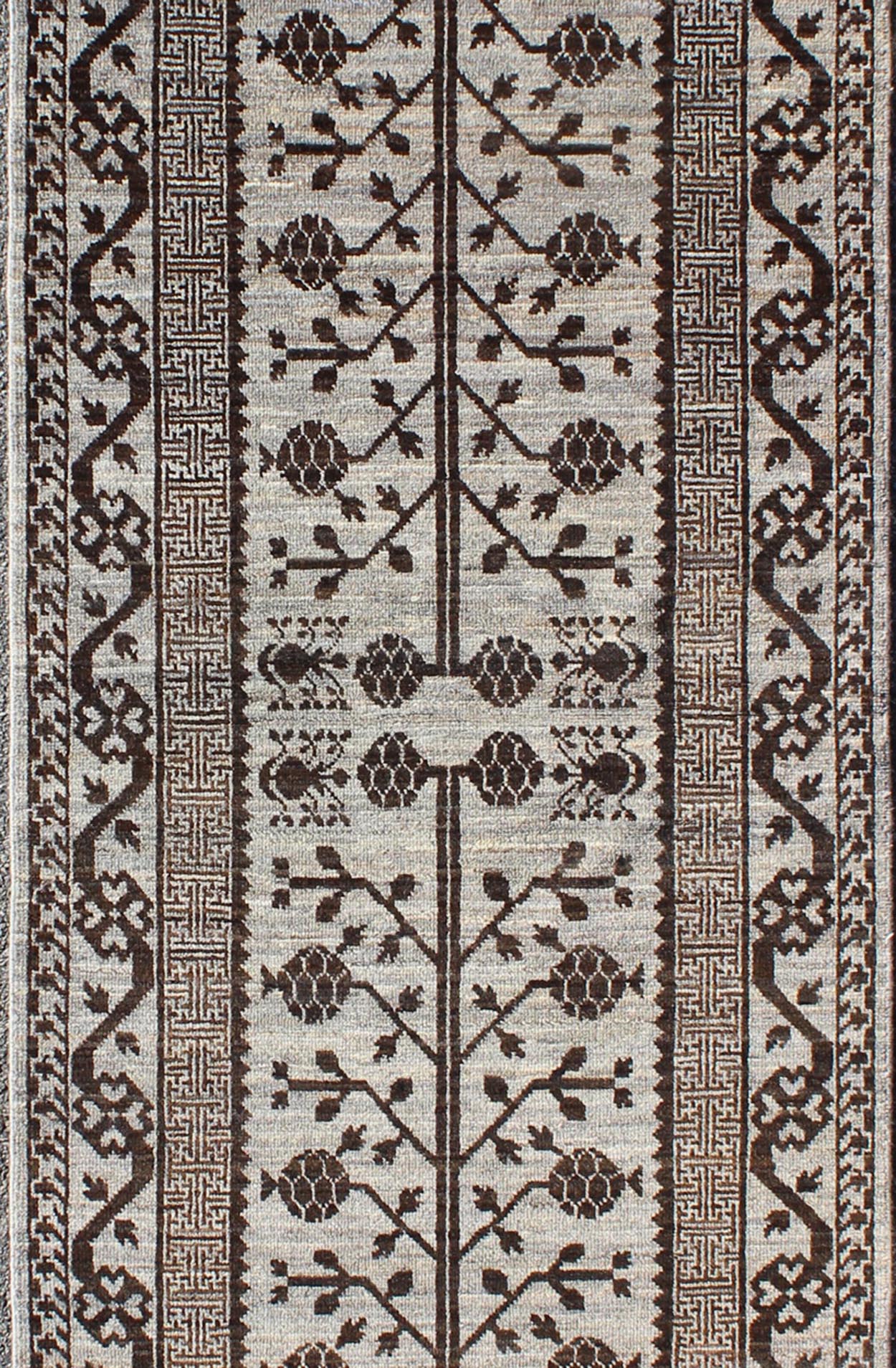 Rug with Geometric Medallions Khotan with Geometric rug MP - 1404 - 909, country of origin / type: Afghanistan / Khotan This Reproduction Khotan features a geometric multi - medallion pomegranate design flanked by a repeating pattern in the field.... - Keivan Woven ArtsMP - 1404 - 909 - 5367Rug