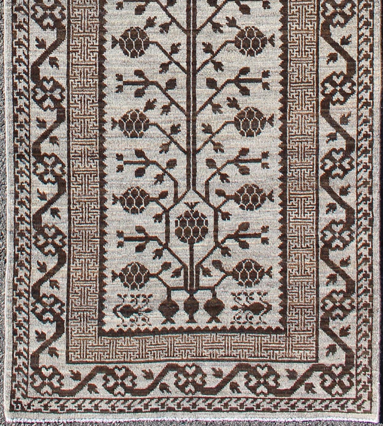 Rug with Geometric Medallions Khotan with Geometric rug MP - 1404 - 909, country of origin / type: Afghanistan / Khotan This Reproduction Khotan features a geometric multi - medallion pomegranate design flanked by a repeating pattern in the field.... - Keivan Woven ArtsMP - 1404 - 909 - 5367Rug