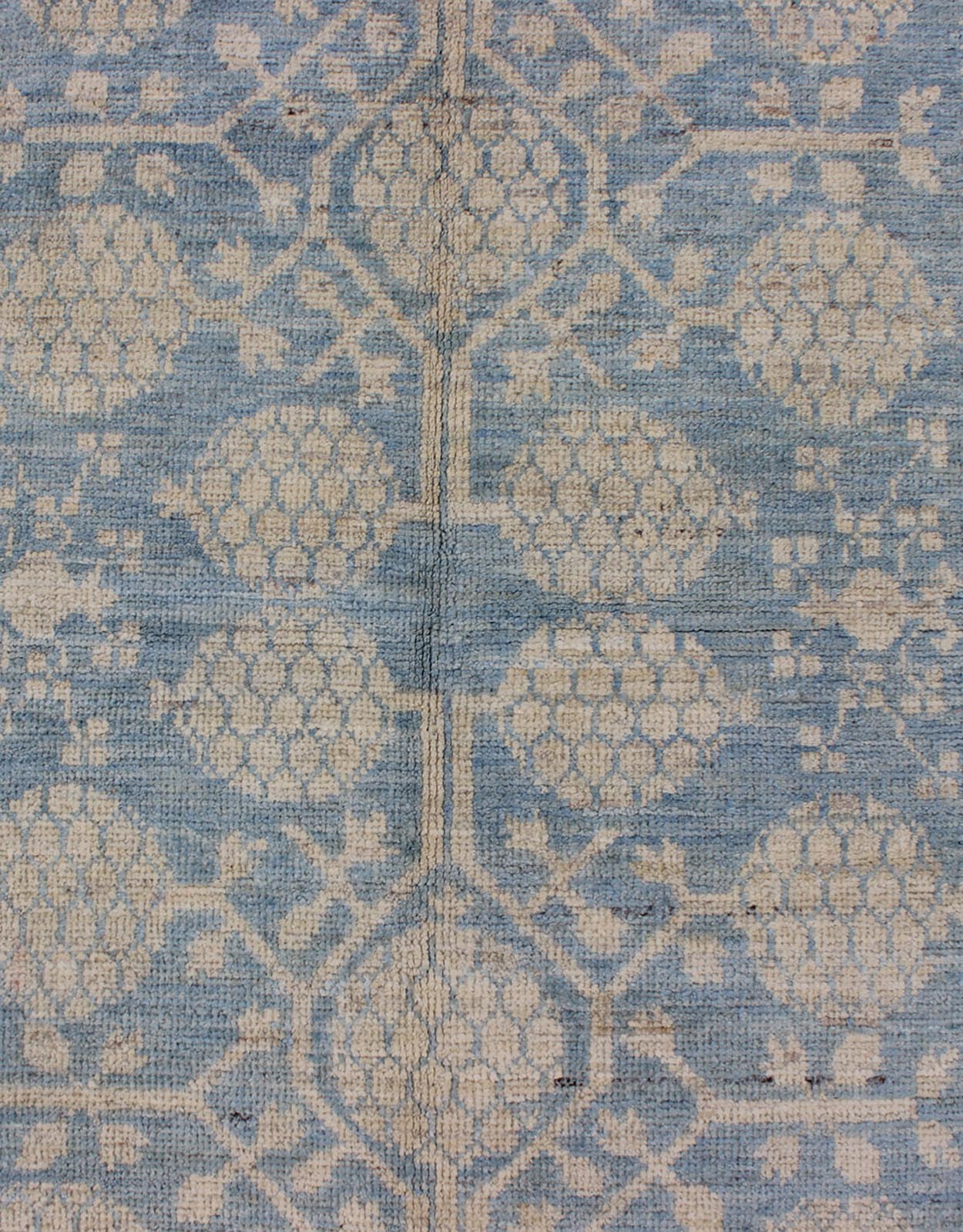 Pomegranate Design Modern Khotan Rug in Light Blue and Cream MP - 1503 - 3571 country of origin / type: Afghanistan / Khotan This Reproduction Khotan features a geometric pomegranate design flanked by a repeating pattern in the border. The entirety ... - Keivan Woven ArtsMP - 1503 - 3571 - 6436Rug