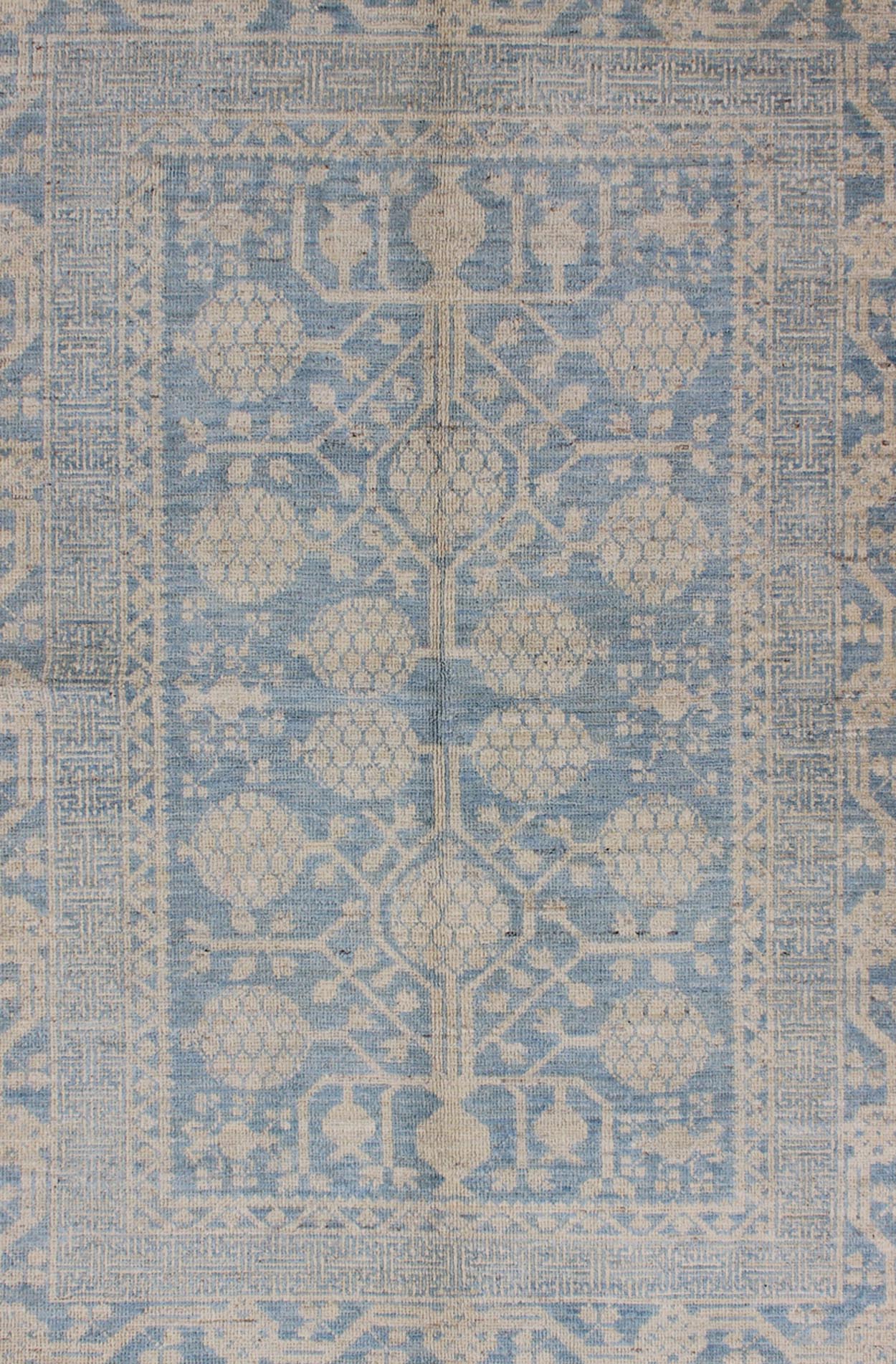Pomegranate Design Modern Khotan Rug in Light Blue and Cream MP - 1503 - 3571 country of origin / type: Afghanistan / Khotan This Reproduction Khotan features a geometric pomegranate design flanked by a repeating pattern in the border. The entirety ... - Keivan Woven ArtsMP - 1503 - 3571 - 6436Rug